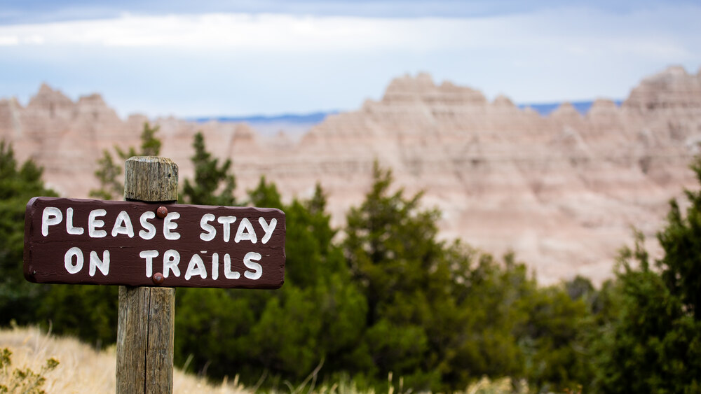 national park sign indicating to stay on trails