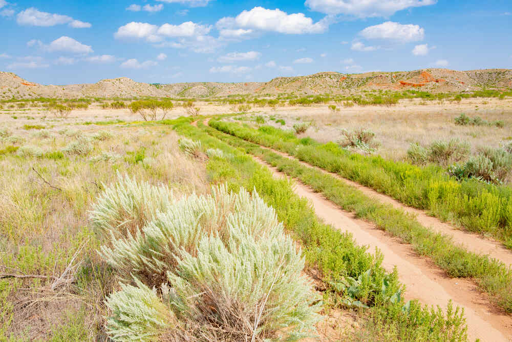 The landscape of Alibates Flint Quarries National Monument in Texas showing rolling prairies and rocky terrain
