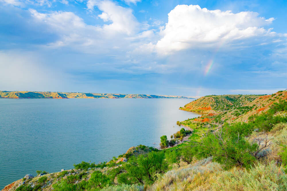 The landscape of Lake Meredith National Recreation Area in Texas features a picturesque reservoir surrounded by high plains, canyons, and rolling grasslands