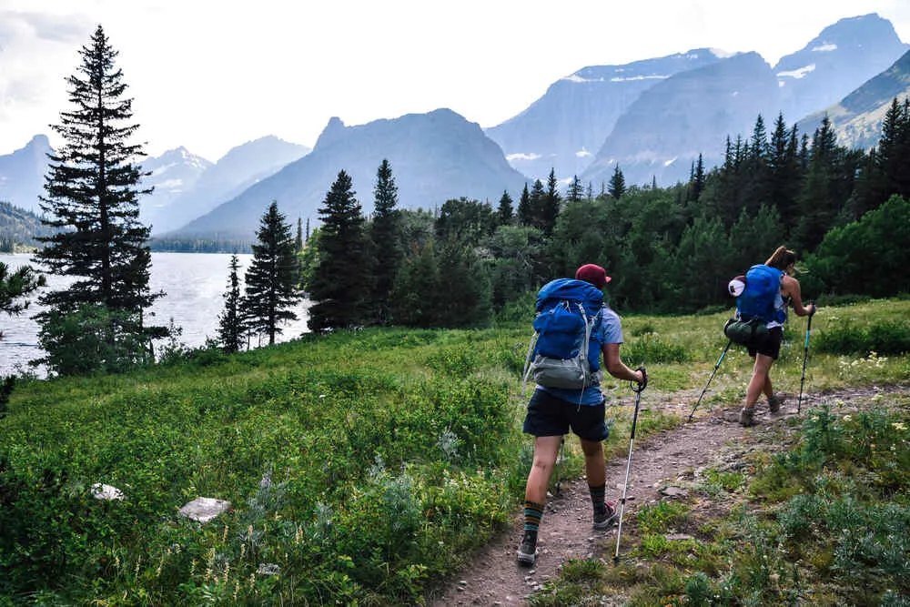 Two hikers enjoy the day hiking through Glacier National Park