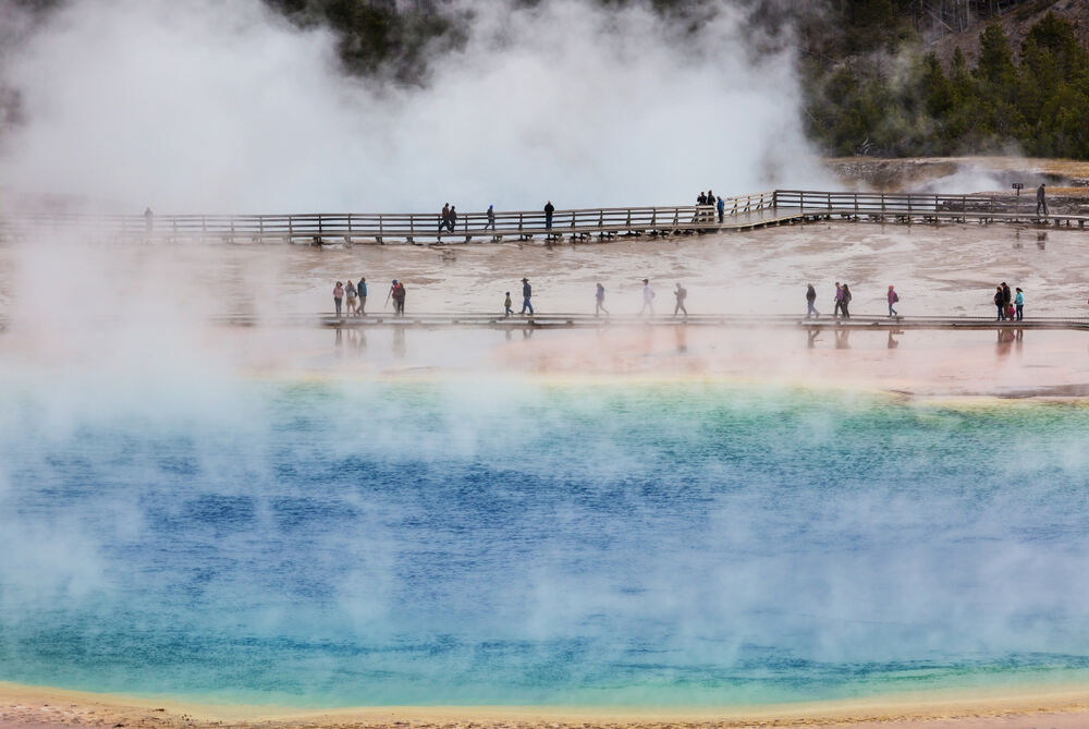 people visiting Grand Prismatic Spring in yellowstone national park in wyoming