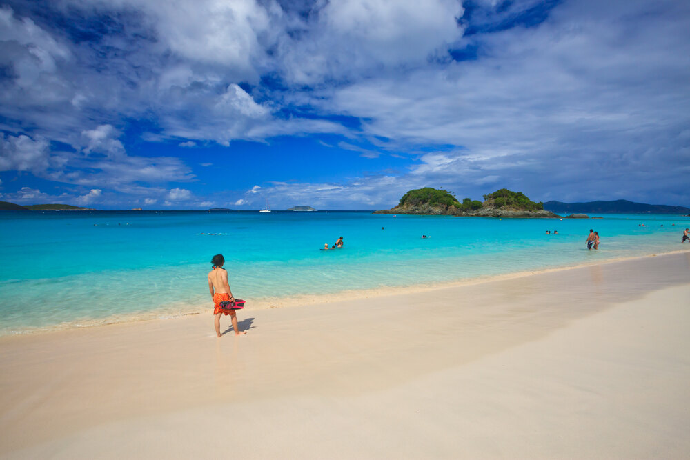 beach goers enjoying the beach at trunk bay in virgin islands np