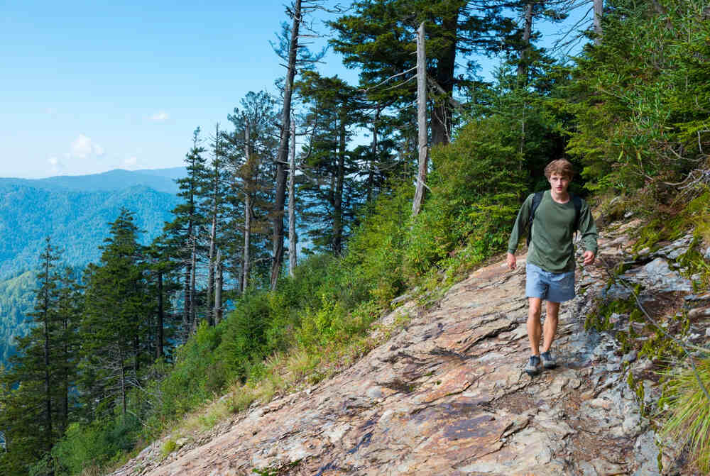 A hiker treks to the Alum Cave Bluffs along the Alum Cave Trail to take in best views