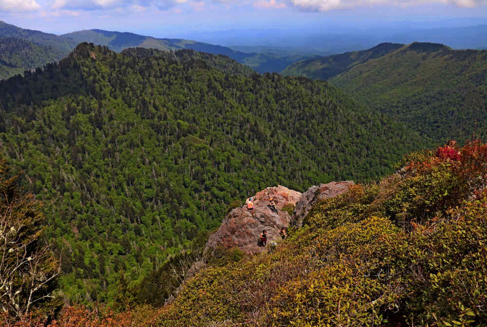 Hikers can be seen along the rocky outcrop admiring the view at Charlies Bunion